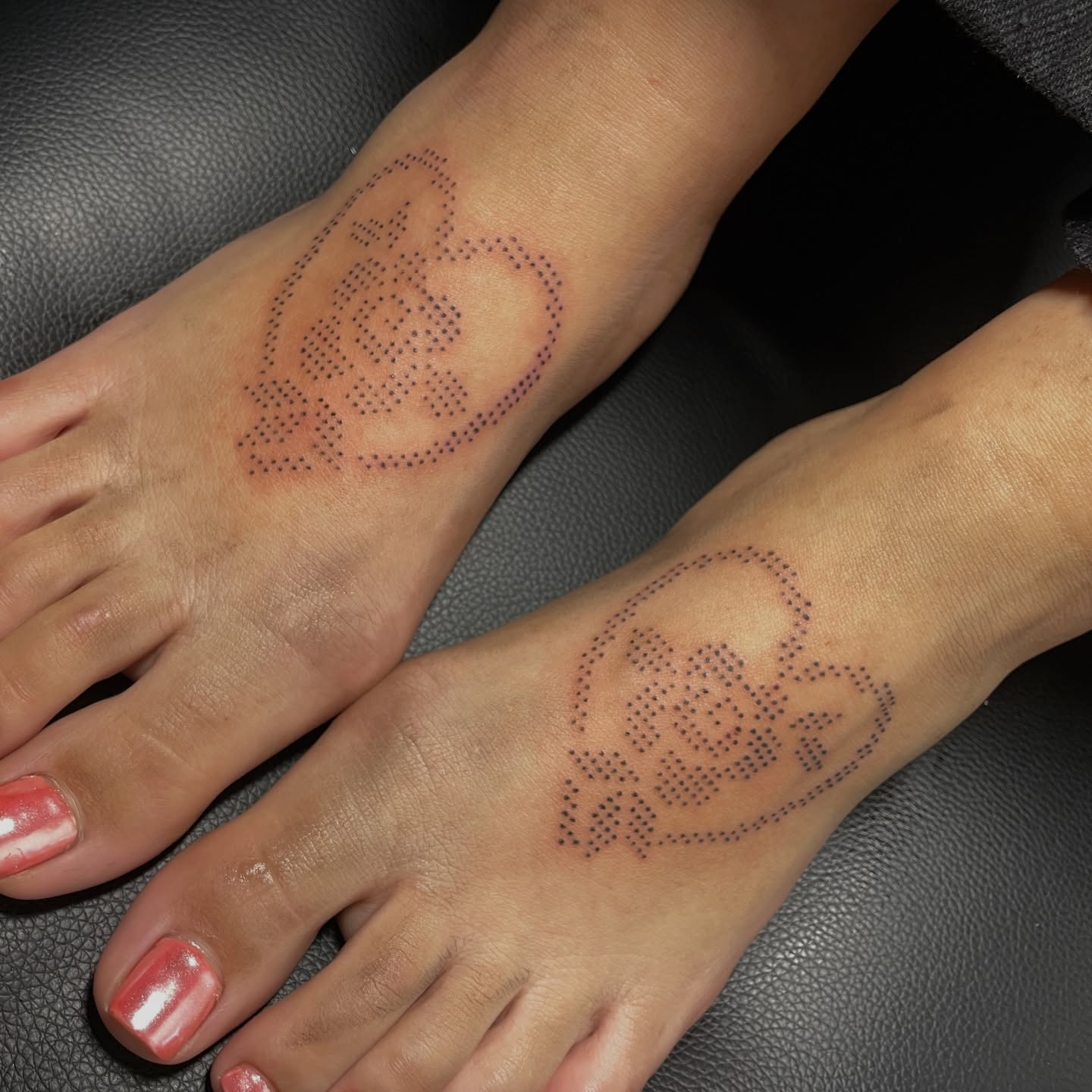 Matching ornamental dotwork tattoos on a client's feet