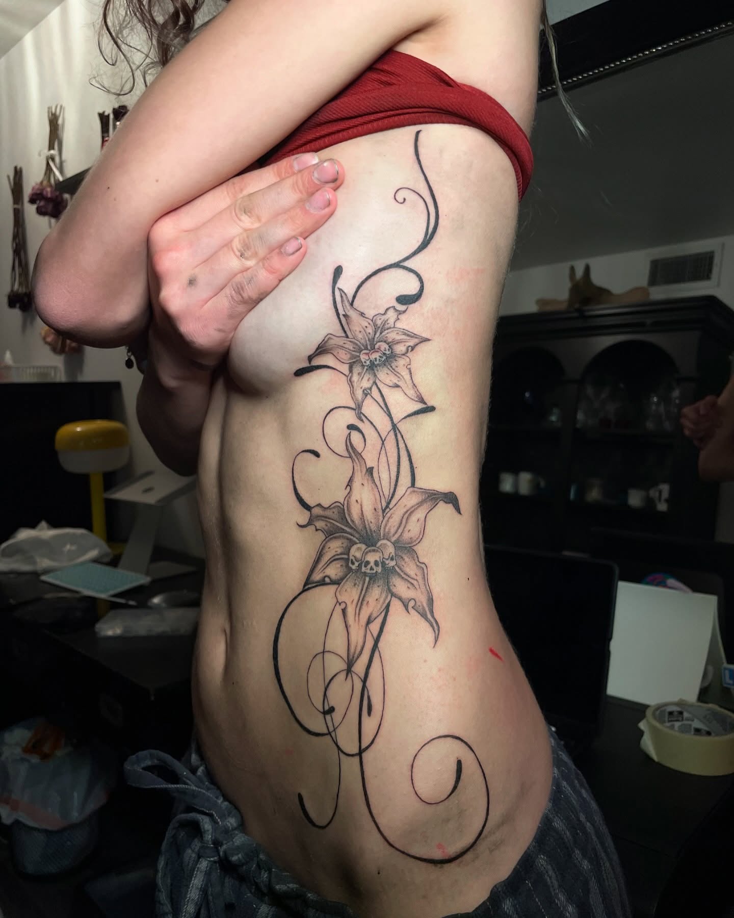 Fine-line lilies with flowing ornamental ribbons on a client's side